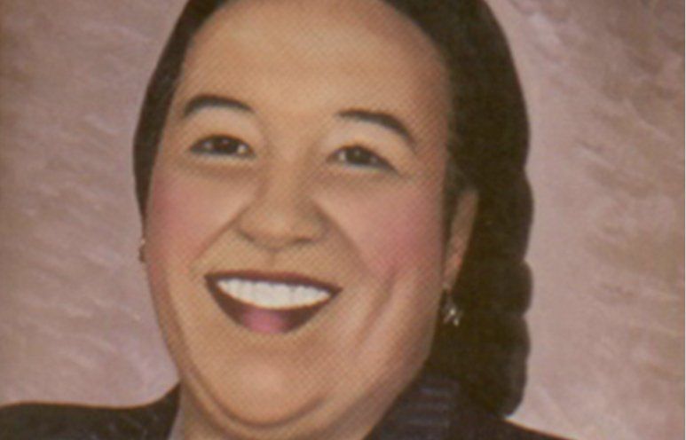 Smiling woman with dark hair, a light complexion, and red cheeks.