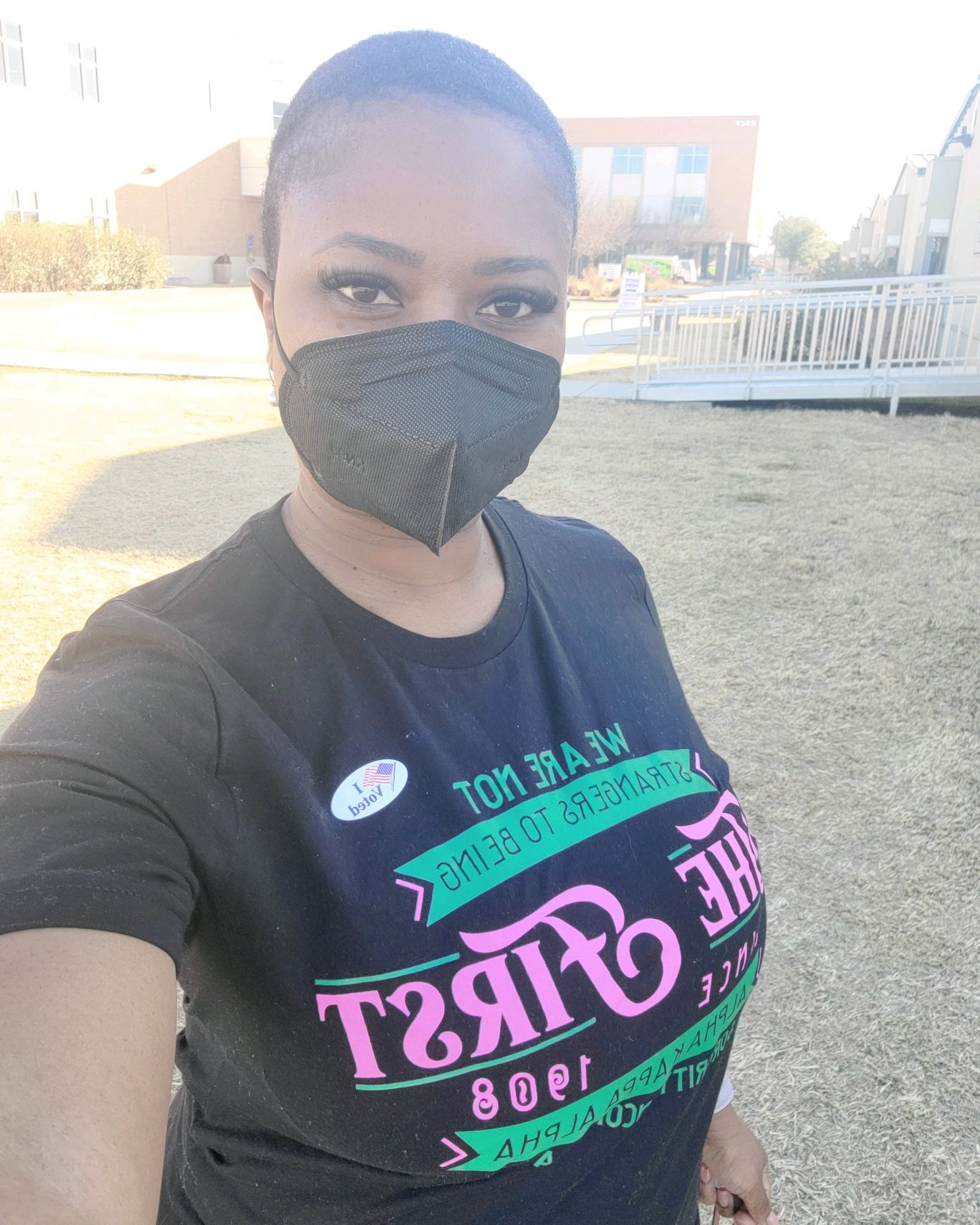Person wearing a black mask and a shirt that reads 
