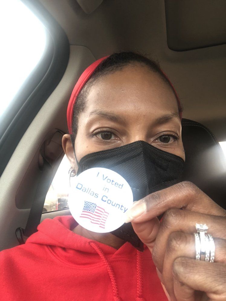 Person in a red hoodie and mask, holding a 