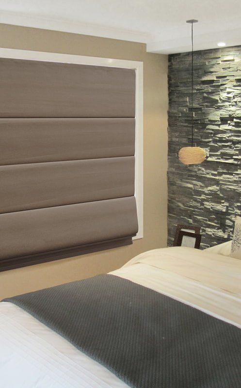 A Bedroom with A Bed and A Stone Wall — Creative Curtains & Blinds In Tweed Heads South, NSW