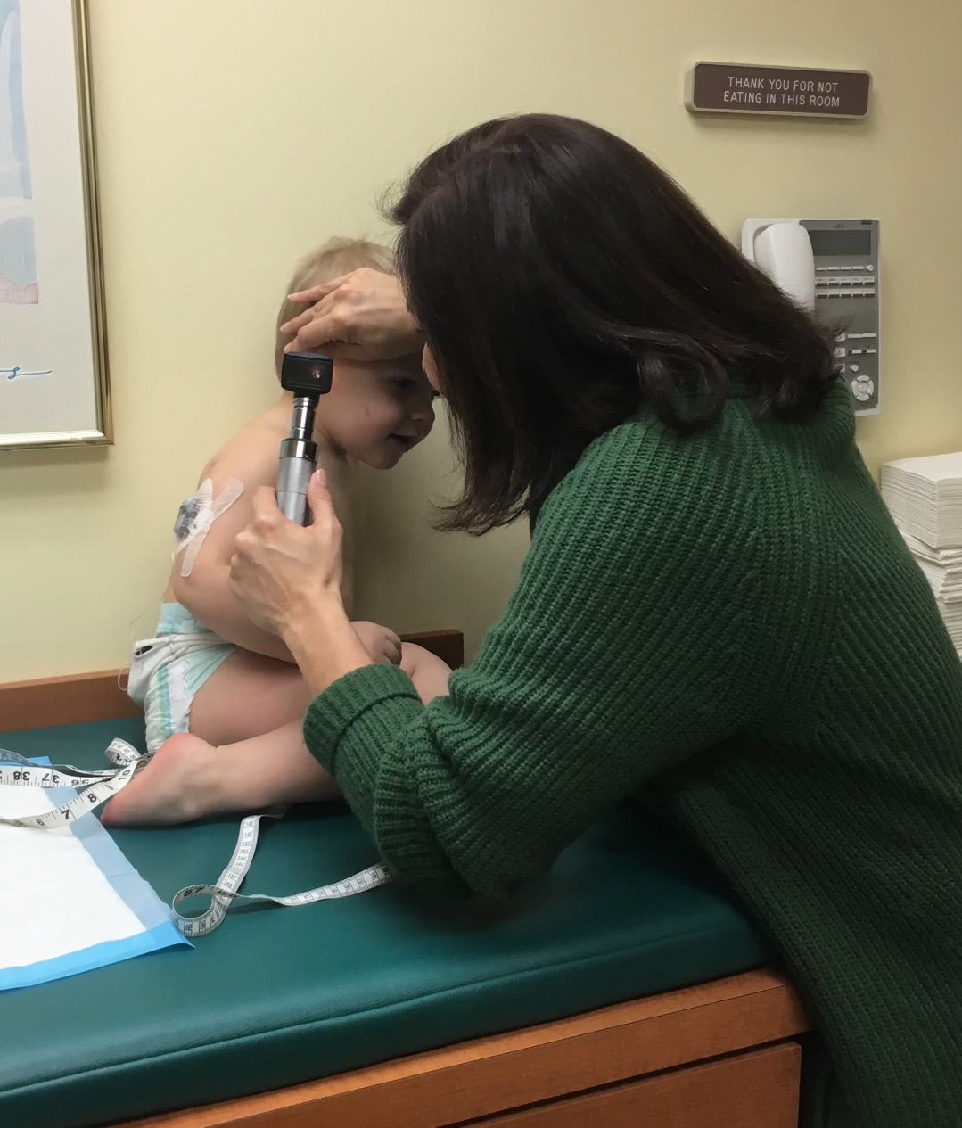 Pediatrician looking into a child's ear