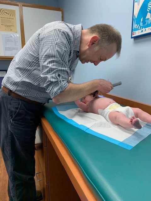 Pediatrician examining a baby