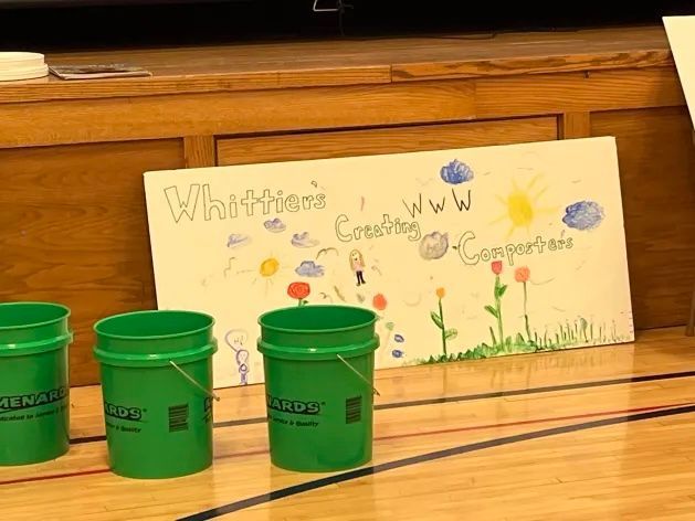 Composting buckets and student art.