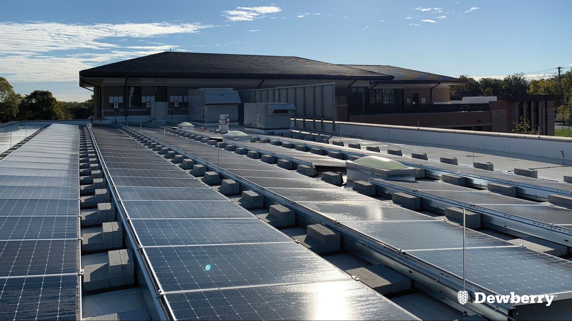 A row of solar panels on the roof of a building