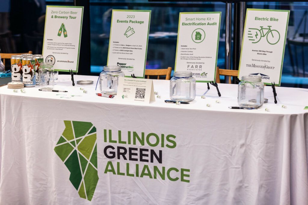 A table with a sign that says illinois green alliance