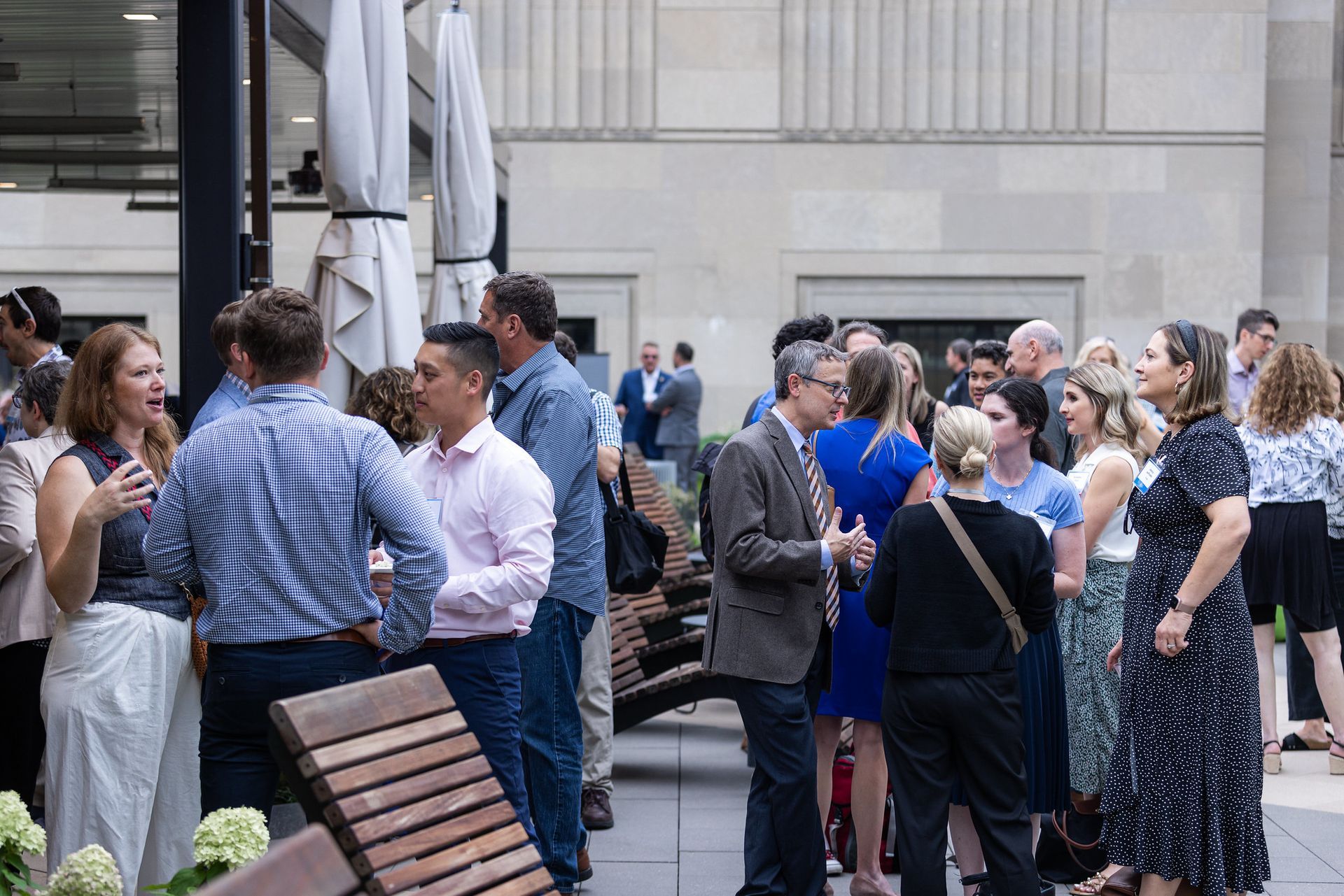 A group of people are standing in a circle talking to each other.