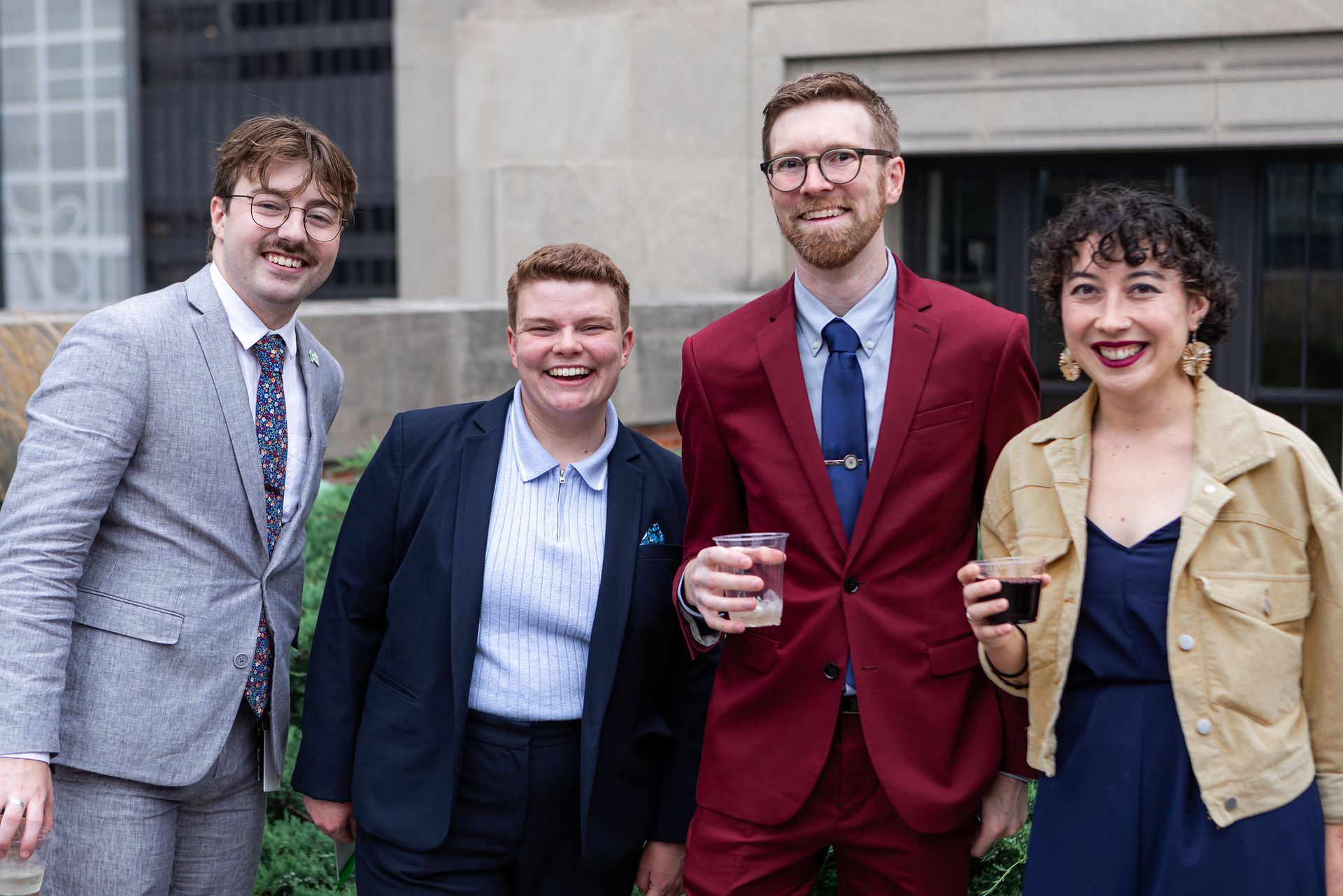 A group of people in suits and ties are posing for a picture.