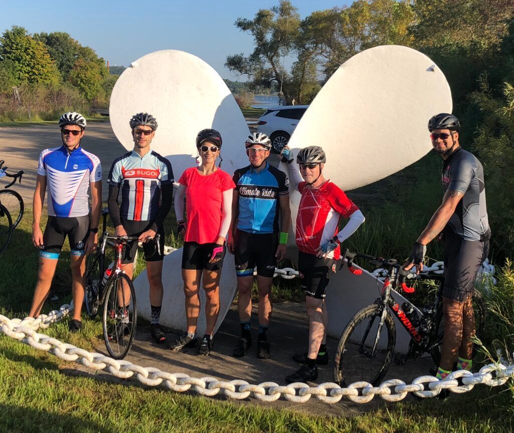 A group of people standing next to each other with bicycles