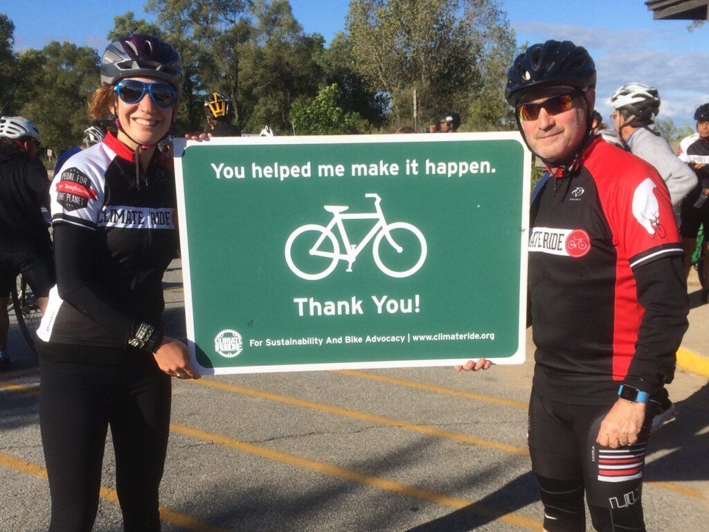 A man and a woman holding a sign that says thank you