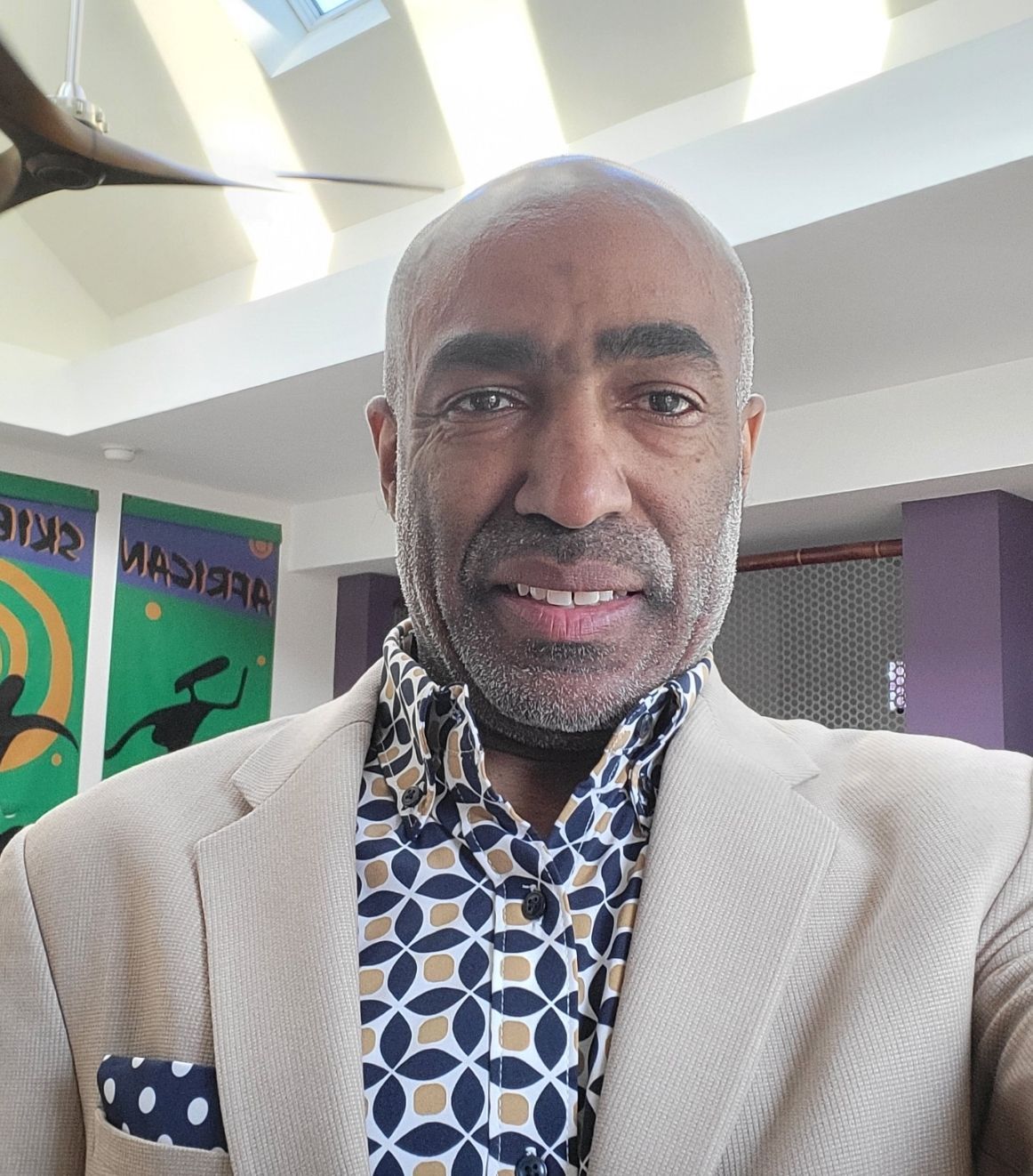 A woman with short hair is smiling for the camera