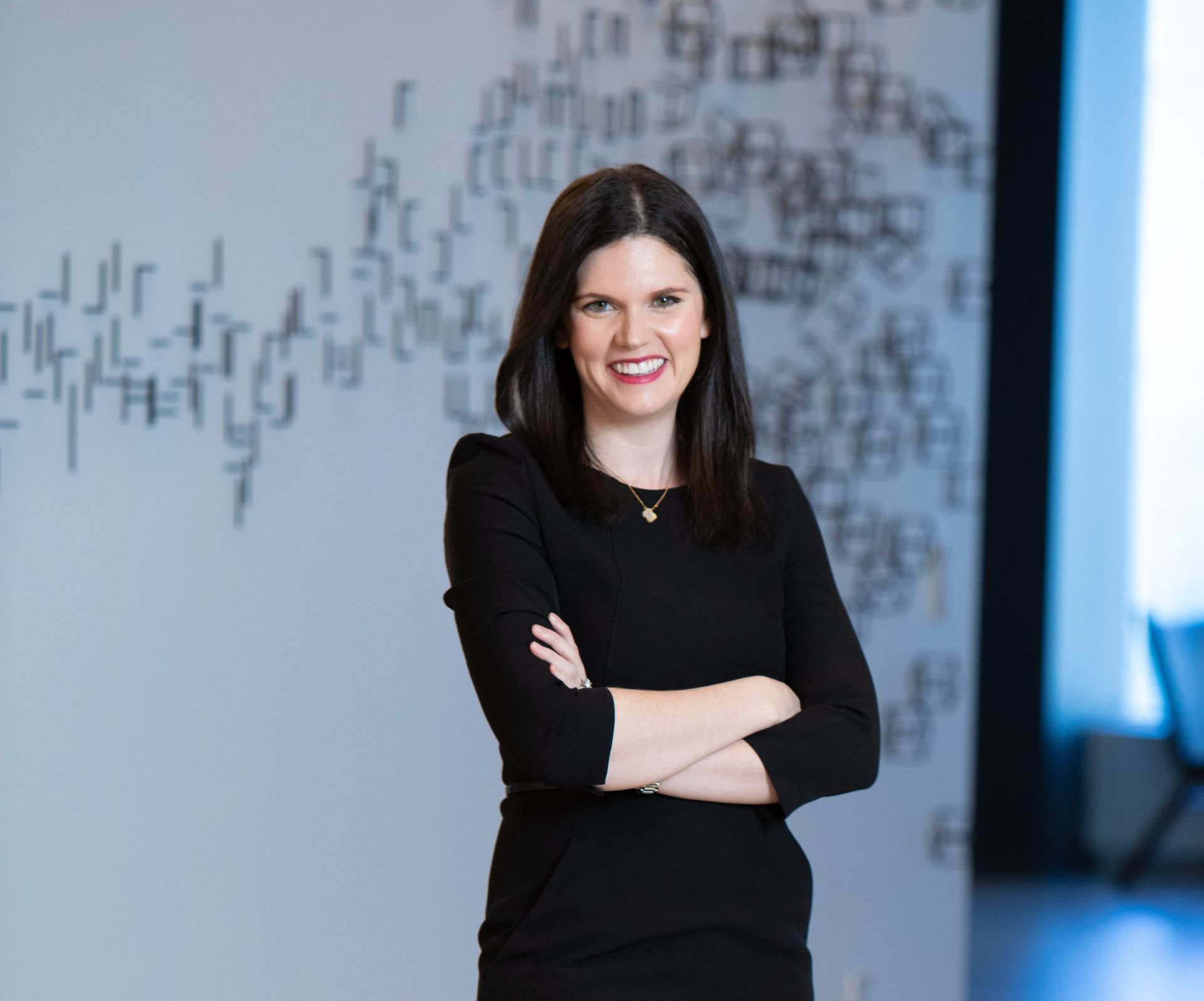 A woman with short hair is smiling for the camera