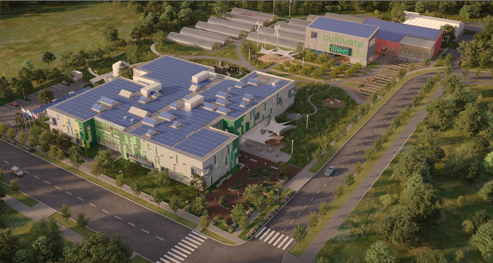 An aerial view of a large building with solar panels on the roof surrounded by trees.