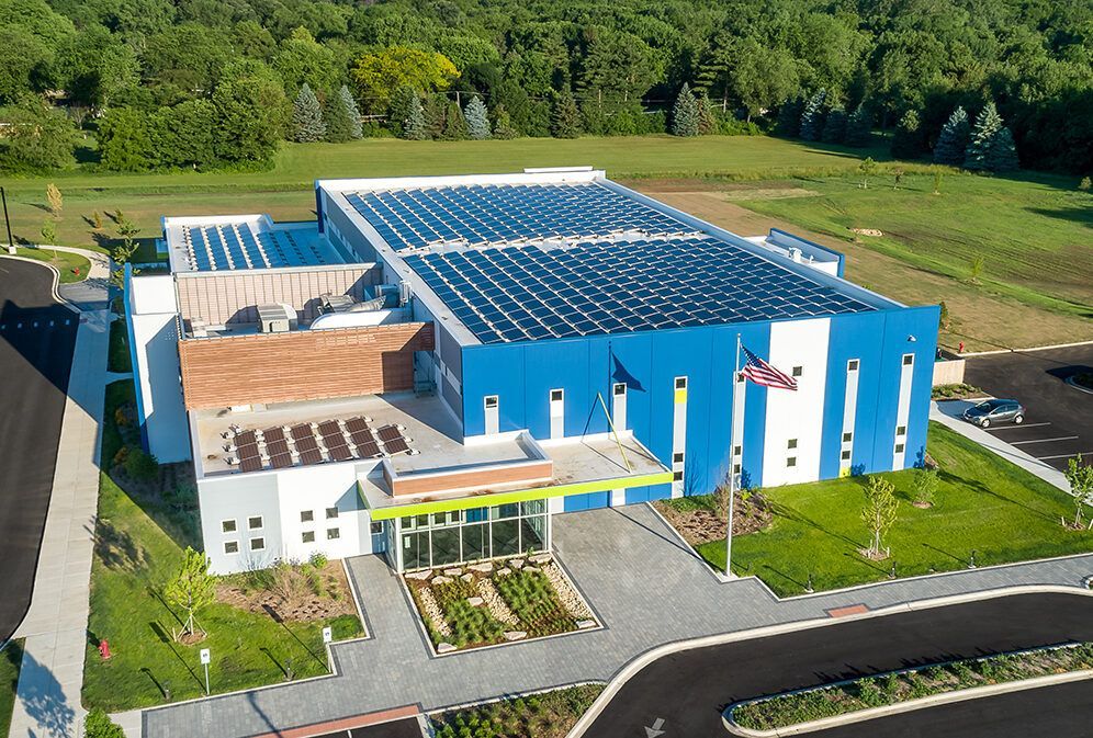An aerial view of a building with solar panels on the roof