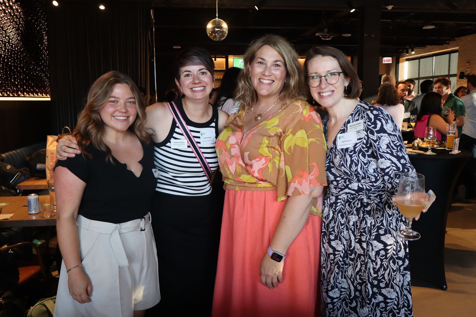 A group of women are posing for a picture in a restaurant.