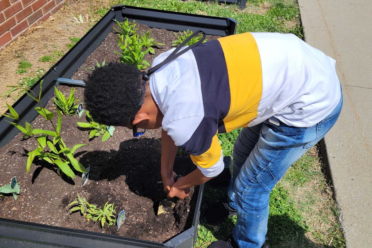 A young man is working in a garden.
