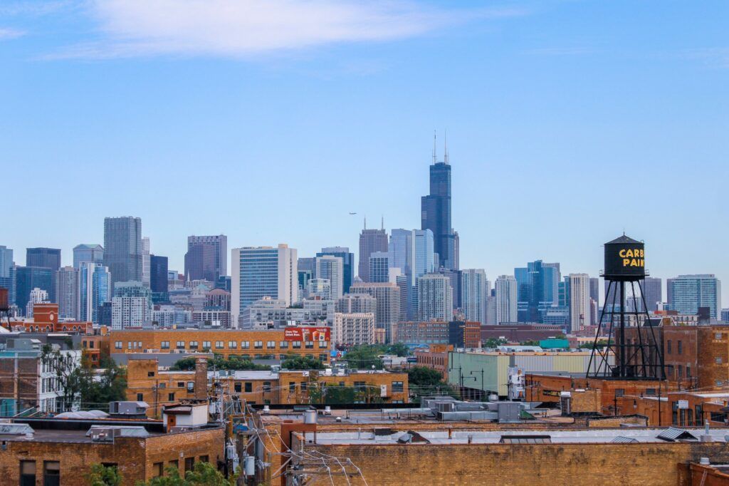 An aerial view of a city skyline with a water tower in the foreground.