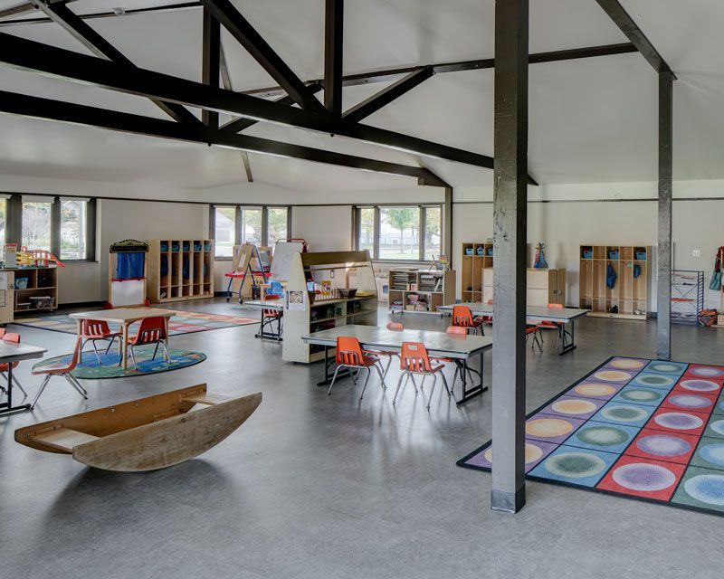 A large room with tables and chairs in it