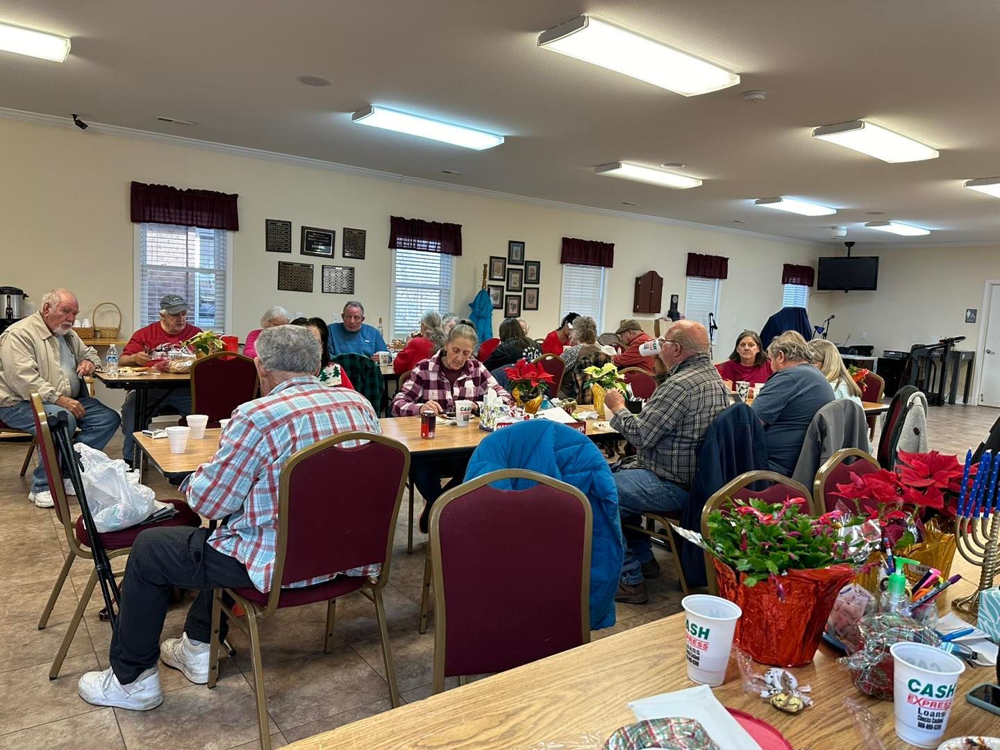 a group of people are sitting at tables in a room .