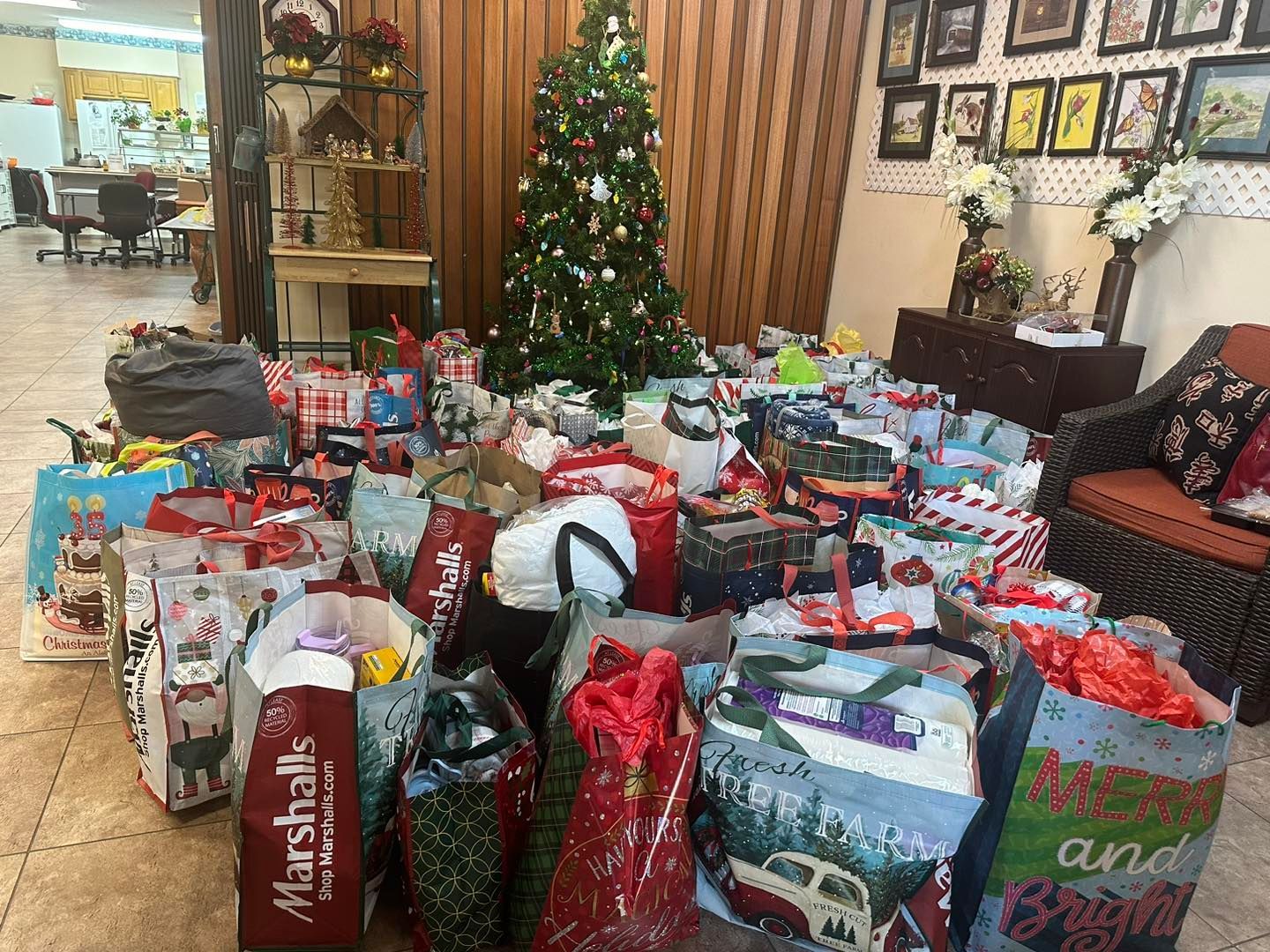 a room filled with lots of christmas presents and a christmas tree .