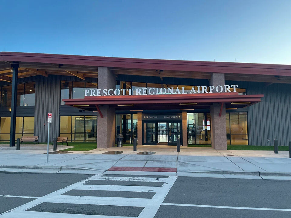 Prescott Regional Airport entrance with signage under a red roof.