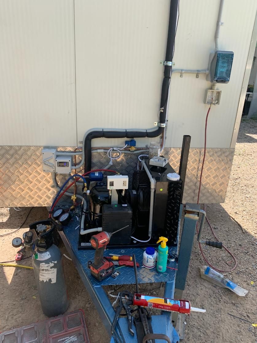 A Table With a Bunch of Tools on It Next to a Trailer — Condie Refrigeration & Air Conditioning In Pottsville, NSW