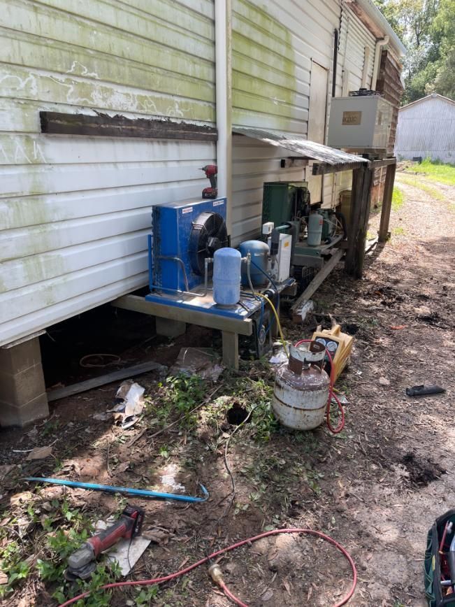 A Machine is Sitting on the Ground in Front of a House — Condie Refrigeration & Air Conditioning In Tweed, NSW