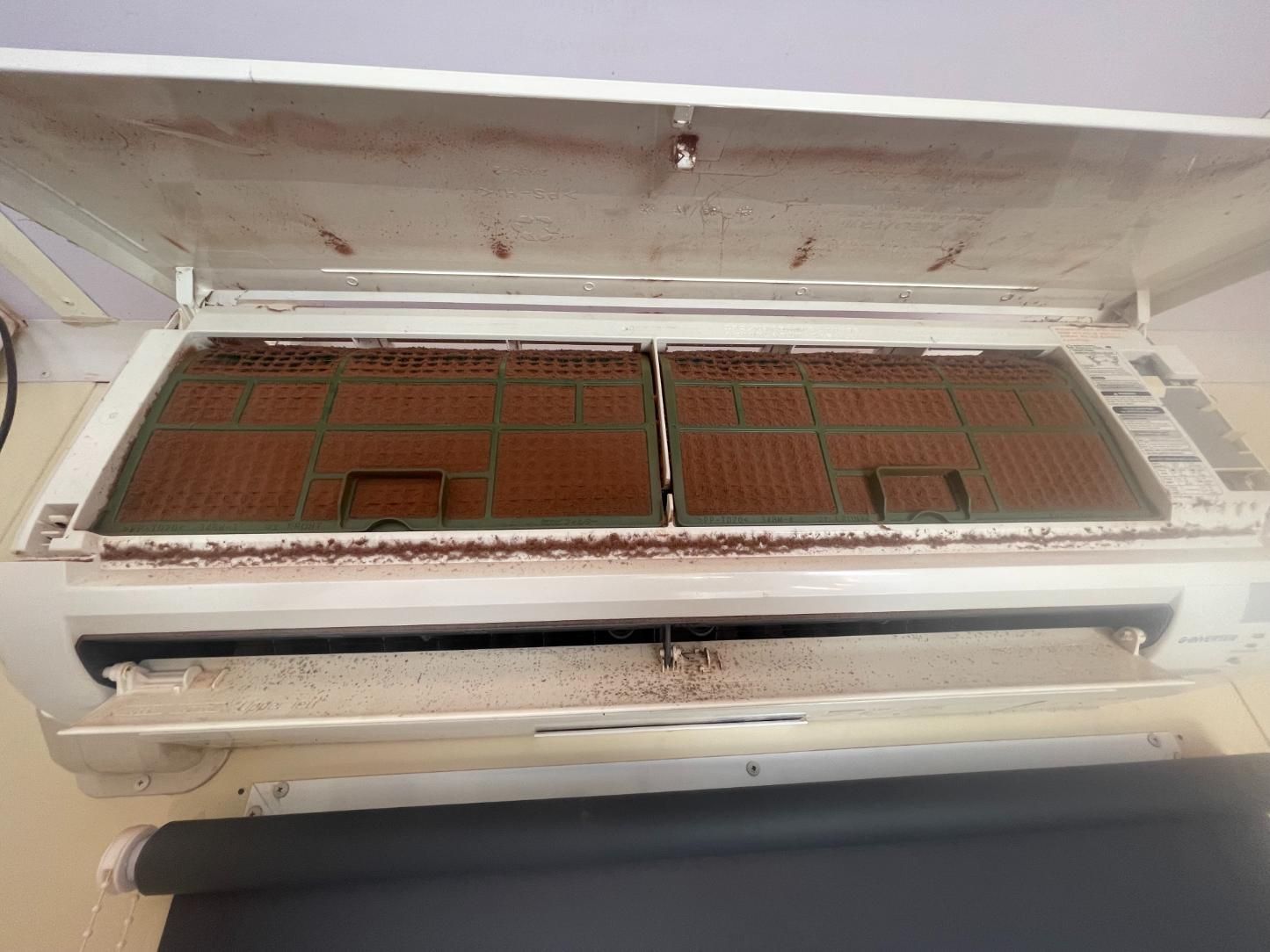 A Dirty Air Conditioner is Sitting on a Table — Condie Refrigeration & Air Conditioning In Tweed, NSW