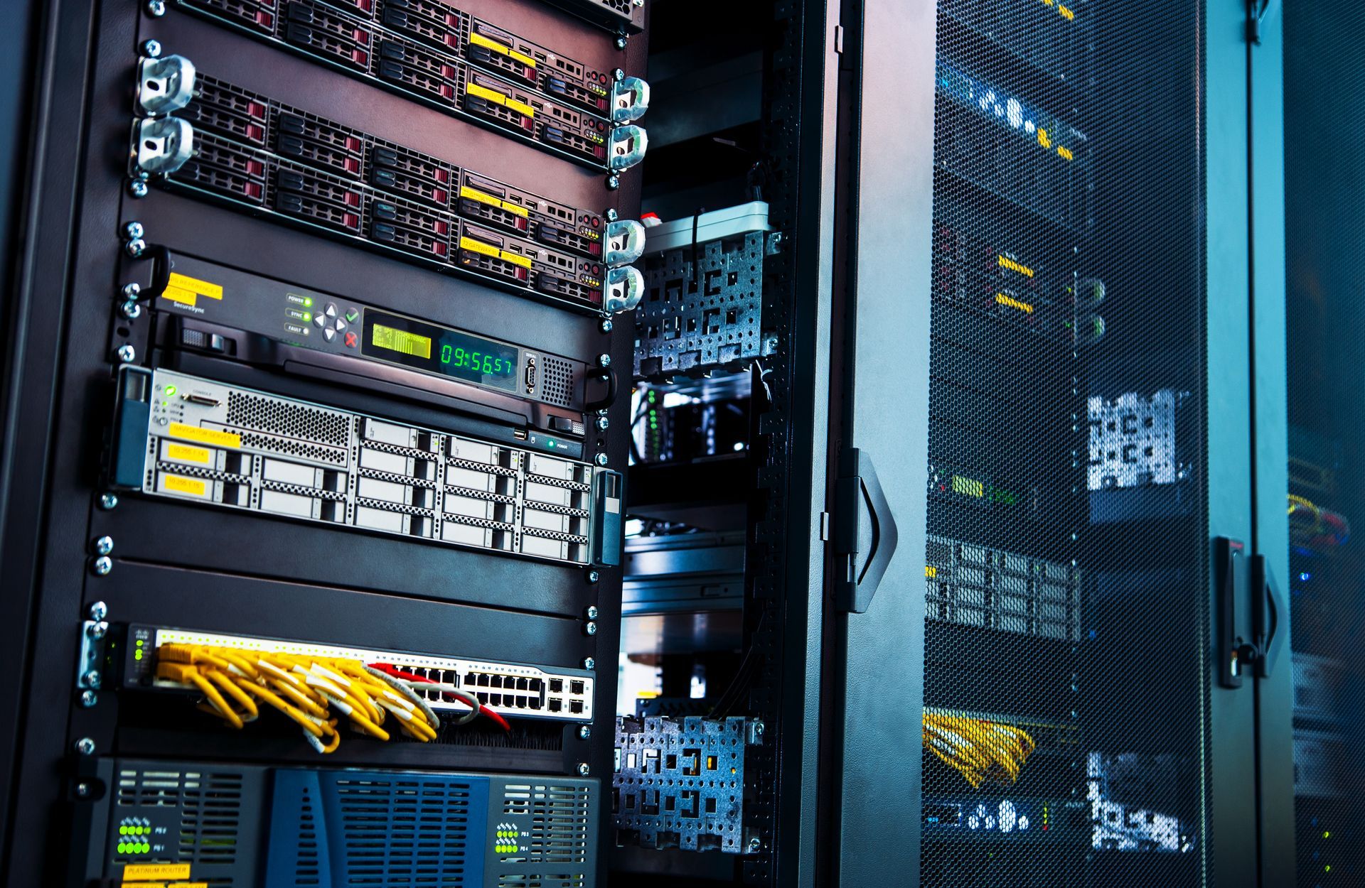 A row of servers in a server room with blue lights on them.