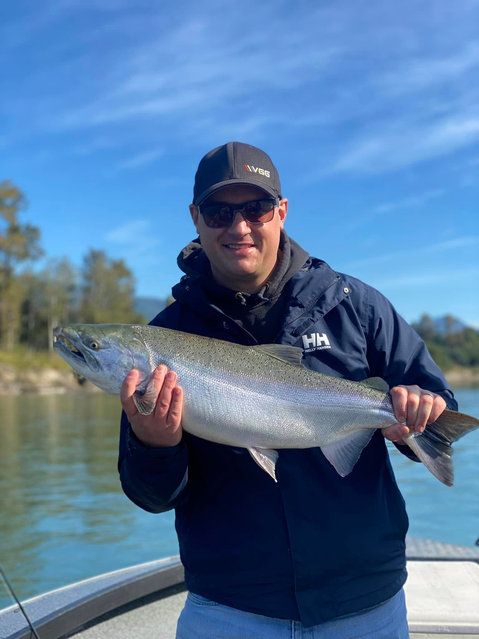 Angler holding trophy coho salmon from Nooksack River fall fishing trip