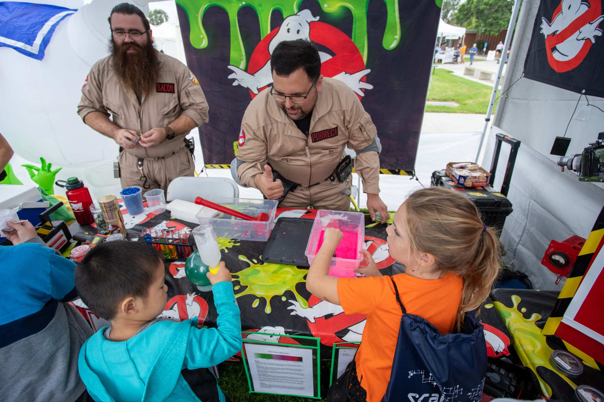Authors Sheri Fink and Derek Taylor smile inside their booth.