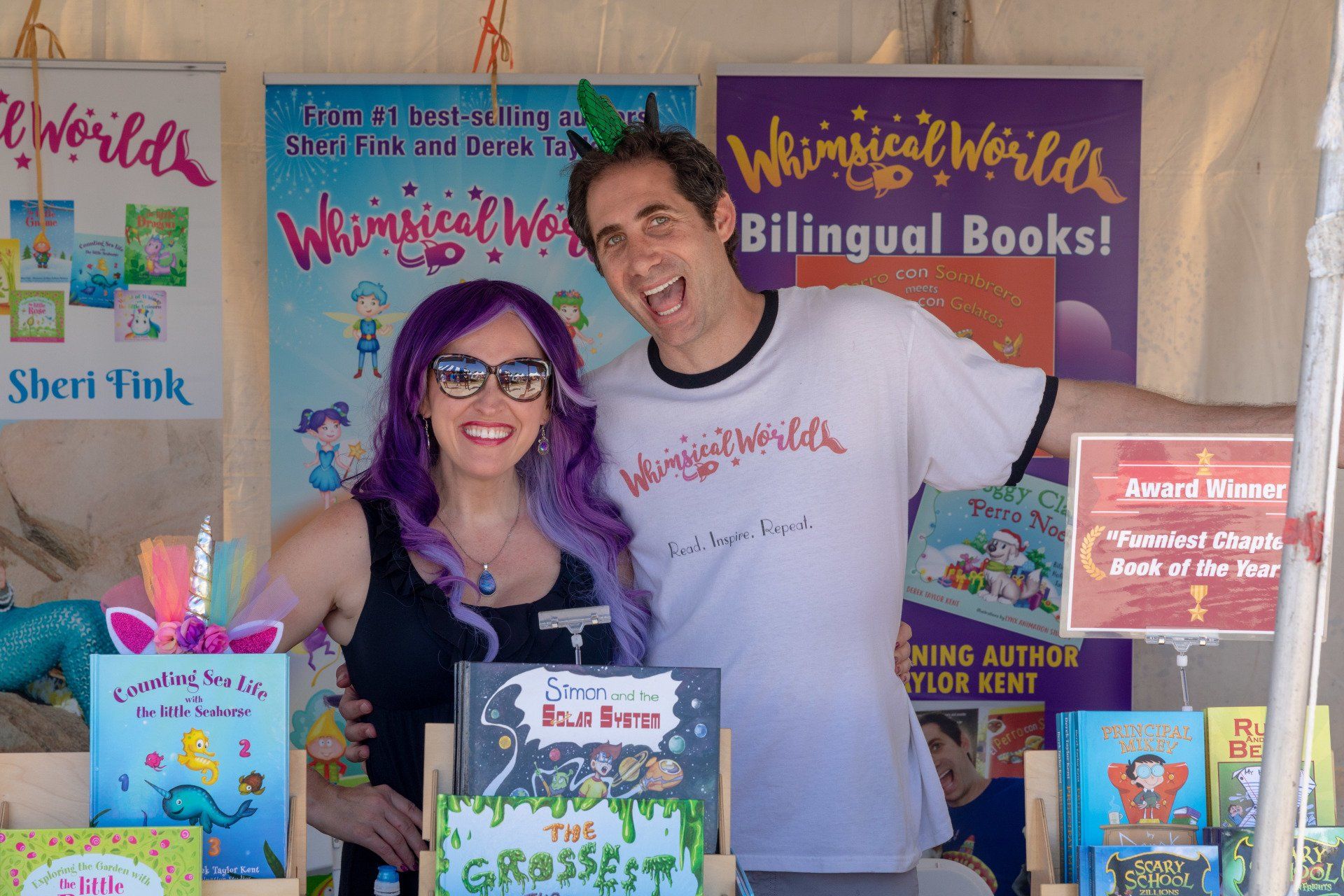 Authors Sheri Fink and Derek Taylor display their books at their booth.