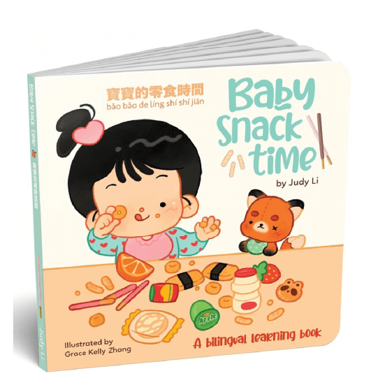 Little girl with snacks in both hands and a little stuffed animal sitting at a table of snacks. Text: Baby Snack Time. A bilingual learning book.