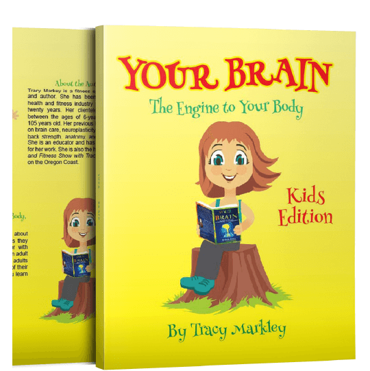 Smiling girl sitting on a tree stump and holding an opened book called Your Brain. Text: Your Brain. The Engine to Your Body. Kids Edition.