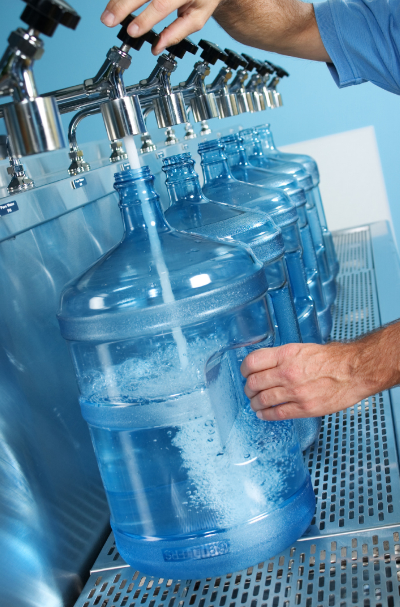 Person filling large refillable bottles at Riverwalk Water, Rosslyn, Pretoria.