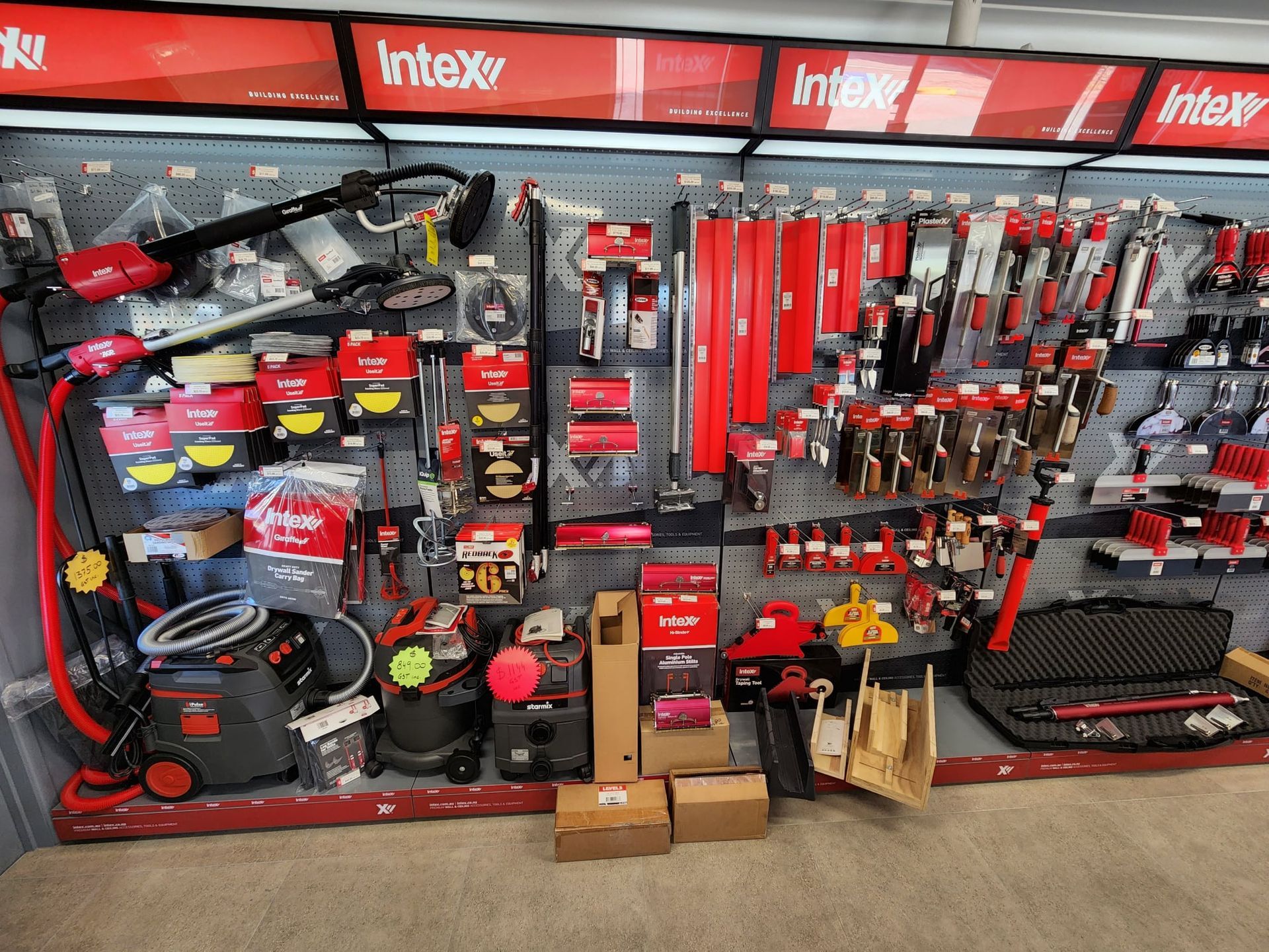 A person is plastering a wall with a trowel.