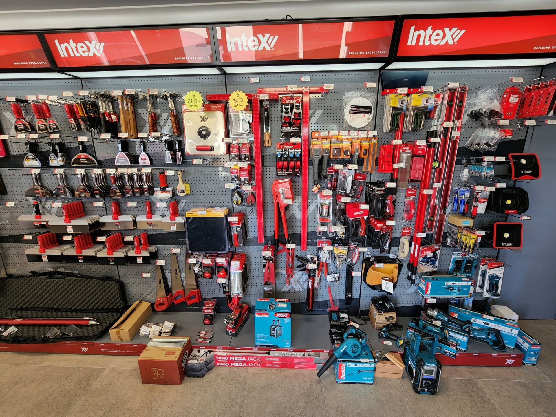 A wall full of tools and a sign that says intex