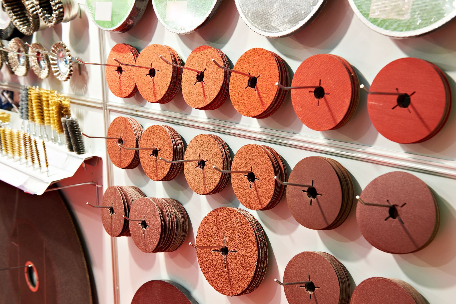 A wall filled with lots of different types of grinding wheels