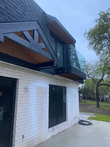 Family gathered at a dining table in a kitchen. They are eating and talking together.