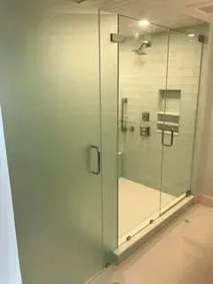 A person holding a baby up in the air indoors near a window, baby smiling.