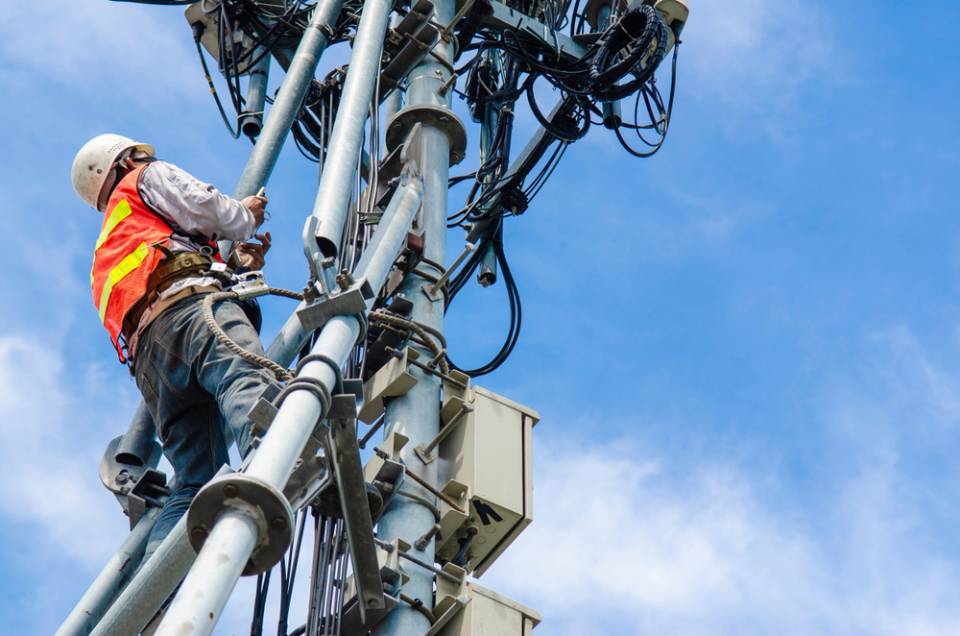 men climbing a tower