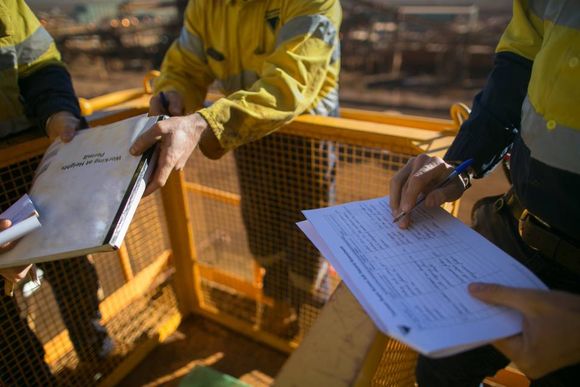 workers signing documents