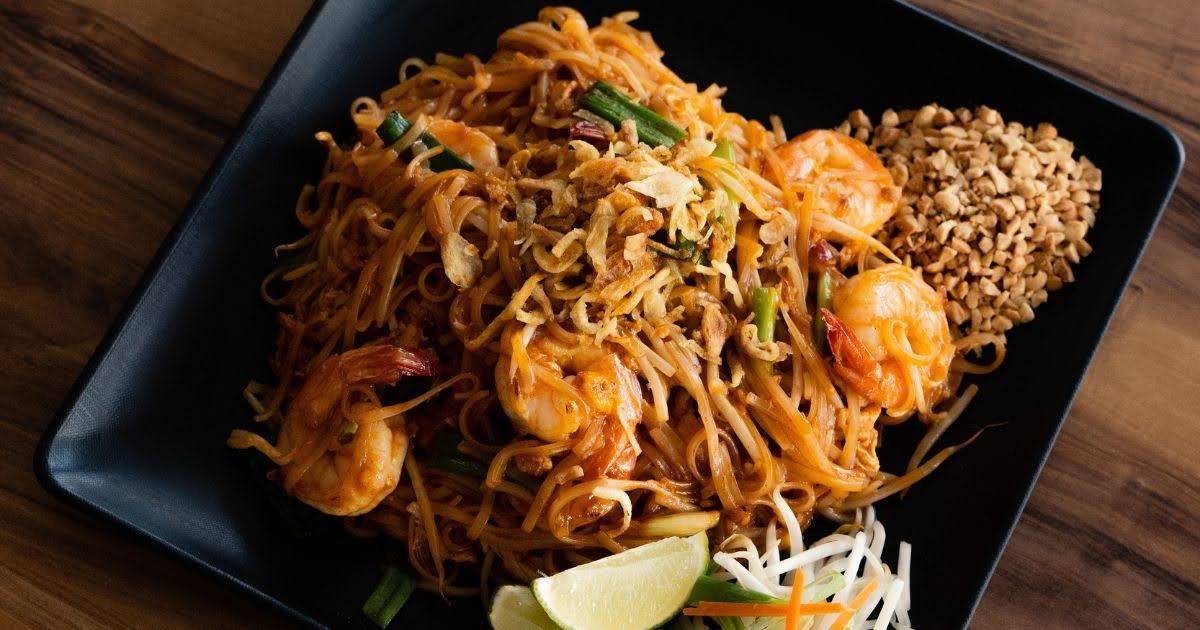 Authentic shrimp Pad Thai takeout from Rickshaw Thai Street Food in Alpharetta, GA – garnished with 