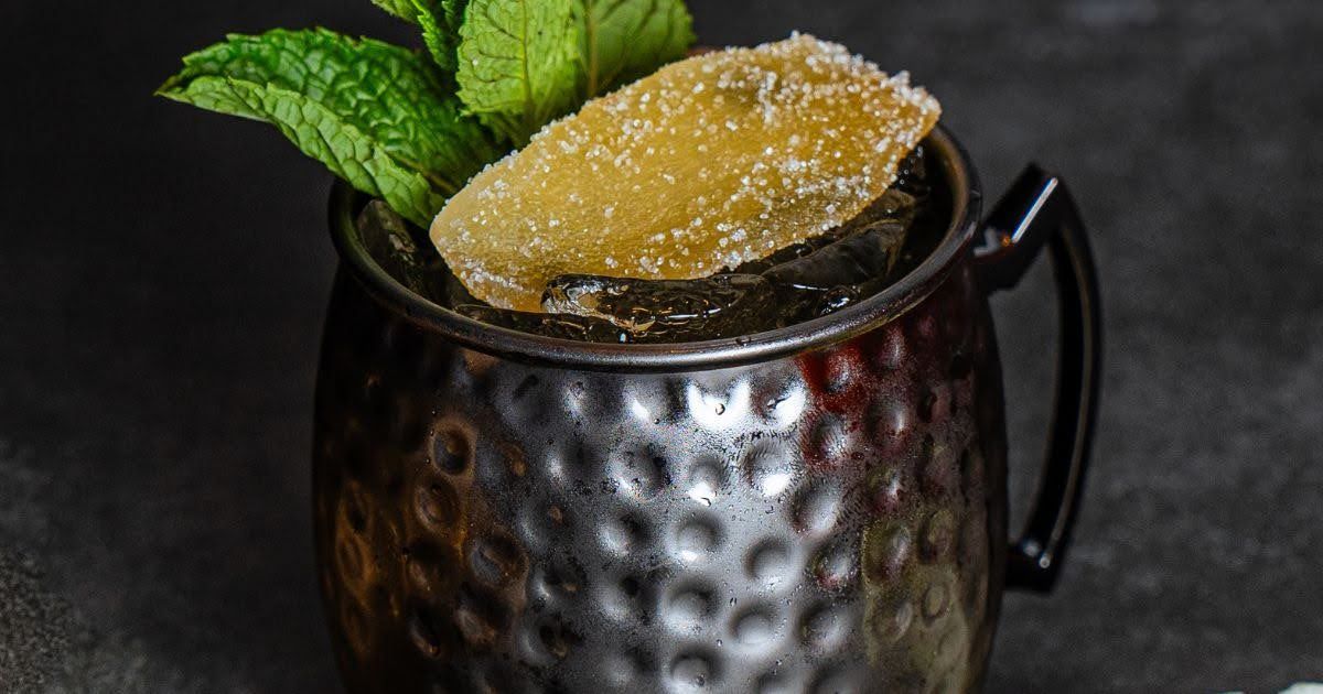 Craft Thai cocktail in a hammered copper mug topped with candied ginger and mint at Rickshaw Thai St