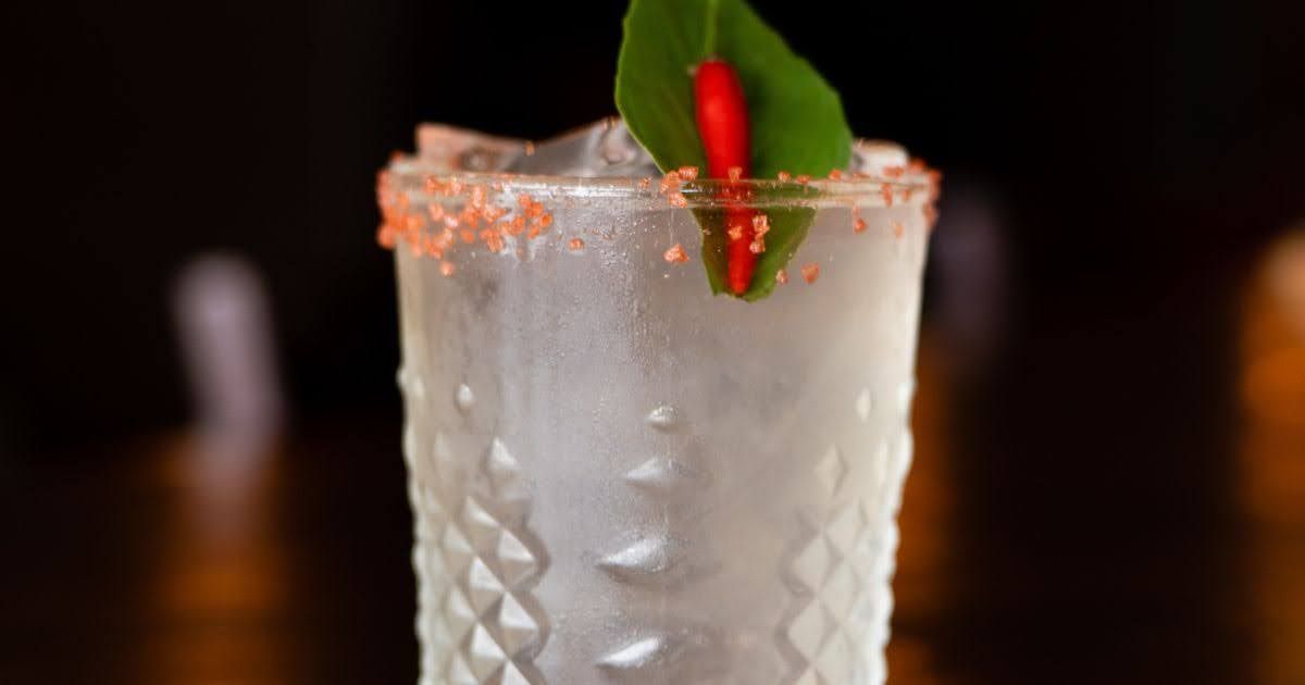 cocktail with chili salt rim, fresh basil, and red chili garnish served at Rickshaw Thai Street Food
