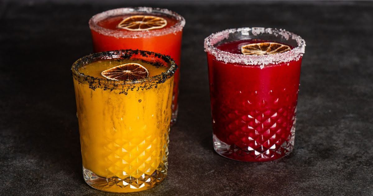 Colorful Thai-inspired cocktails with salted rims and dried citrus garnishes, served at Rickshaw Tha