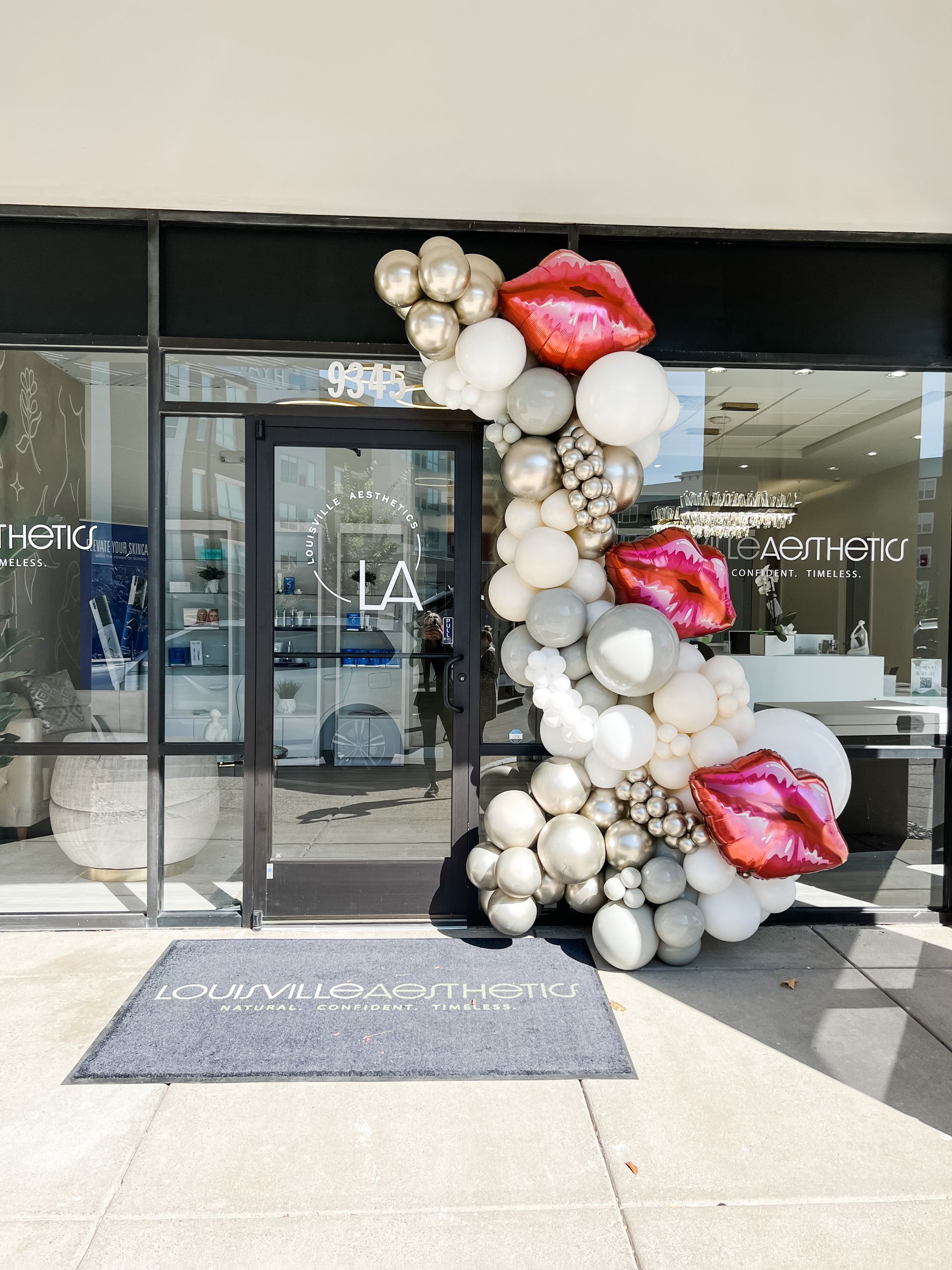 a bunch of balloons are hanging on a wall in a room