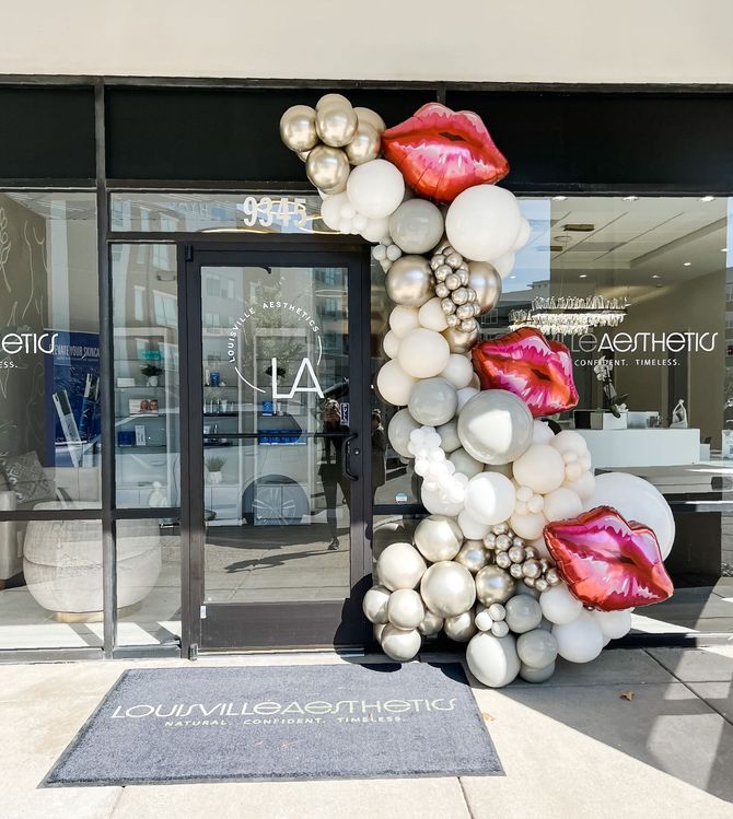 a store front with balloons in the shape of lips