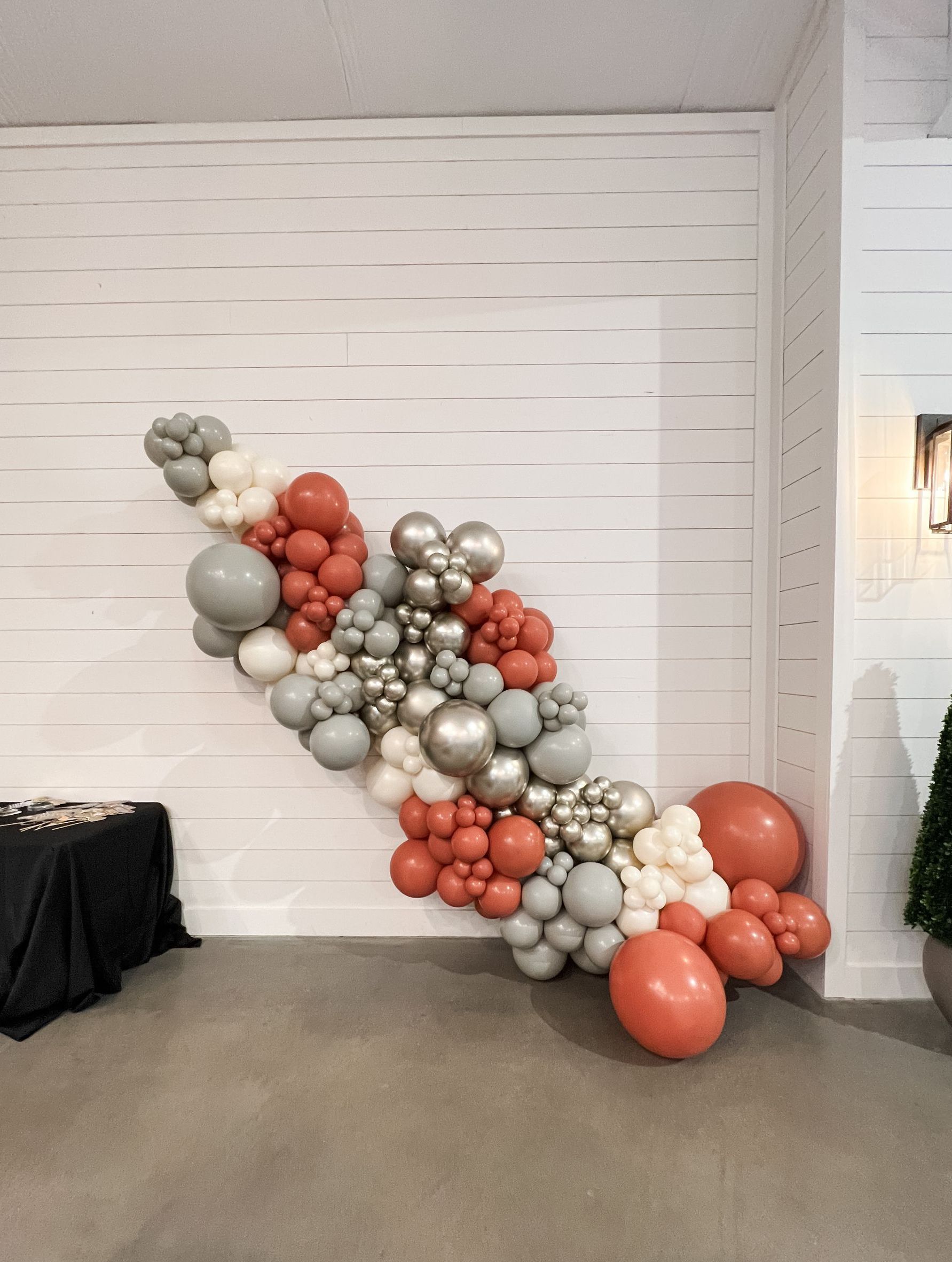 a bunch of balloons are hanging on a wall in a room
