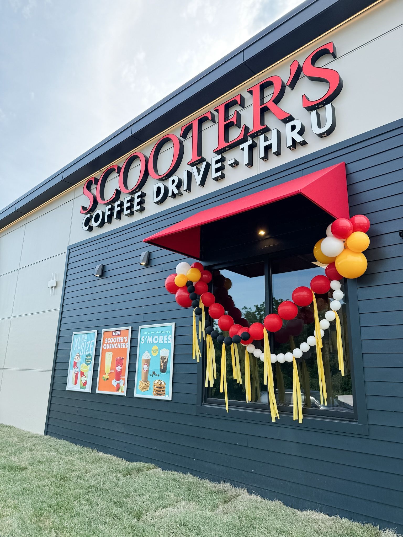 a woman is hanging balloons on a wall