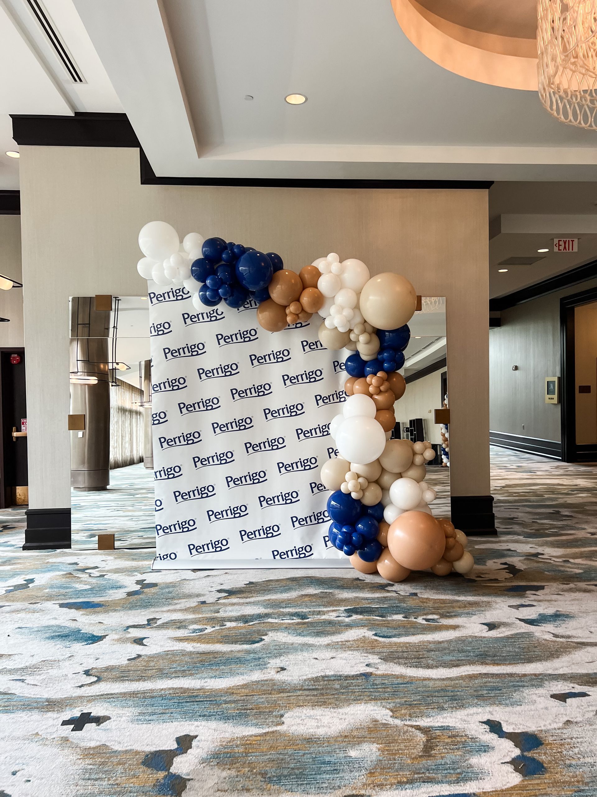 a room with a wall covered in balloons and a carpet